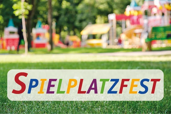 Spielplatz mit bunten Geräten und dem Schriftzug ‚SPIELPLATZFEST‘ auf der Wiese